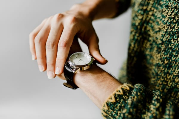 Hand touching a wrist watch