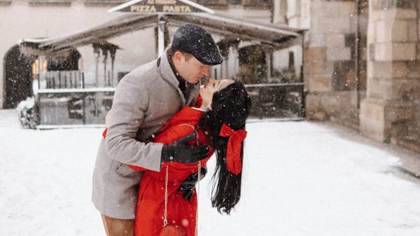 Romantic couple poses in snowy Prague during a winter photoshoot | Professional photographer captures intimate moments